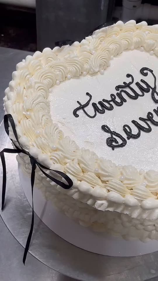 A message piped by hand onto a finished cake