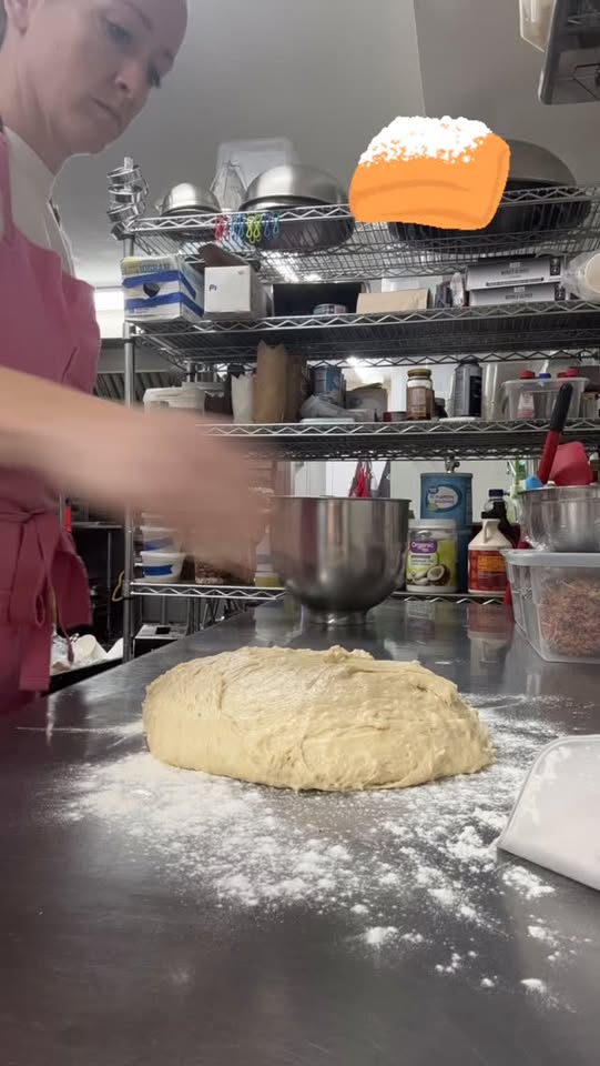 Rolling dough by hand on the bakery bench
